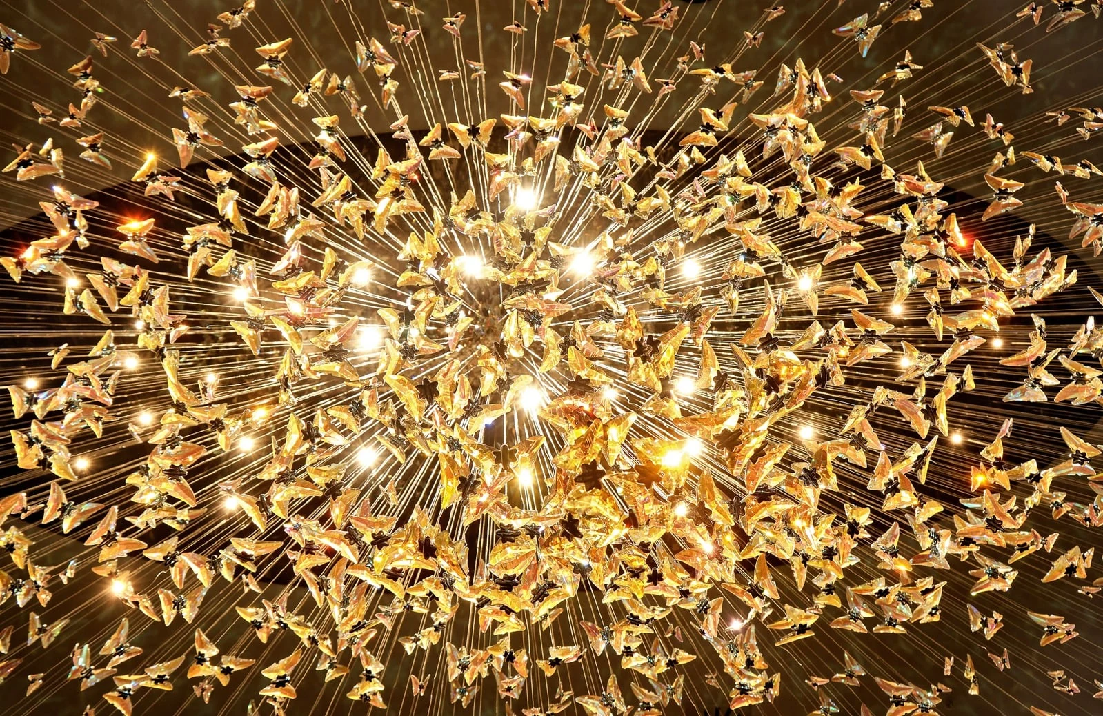 Golden chandelier detail in a richly textured interior