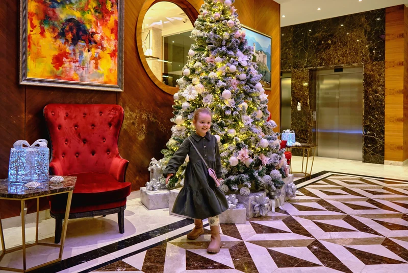 Family enjoying a richly furnished hotel lobby